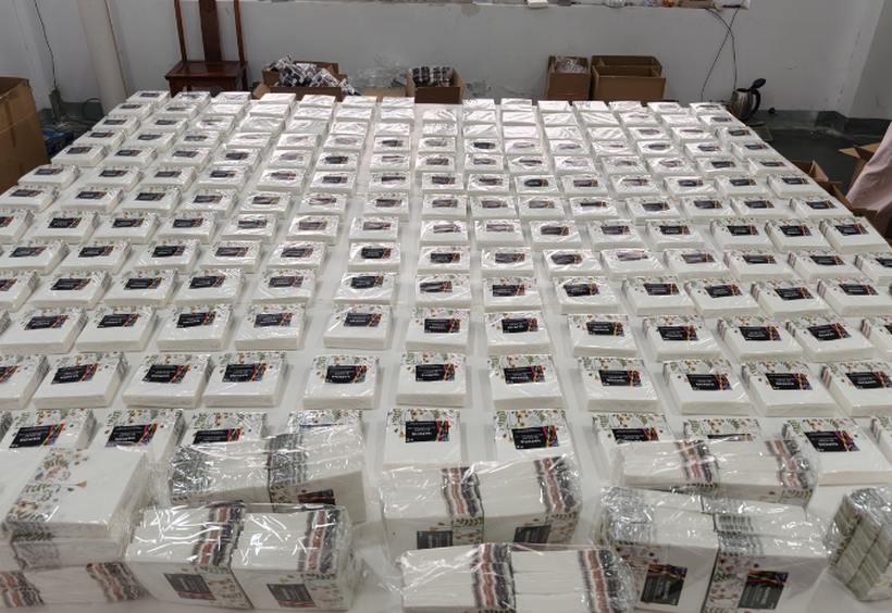 Cow print napkin packs arranged in rows for inspection